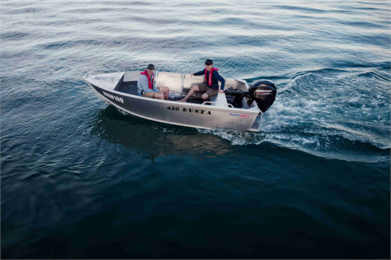 Two men in life jackets cruise through deep blue water in a Quintrex Busta tinnie boat with a Mercury outboard motor.